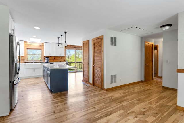 354 Sunset Hill Rd E, Fishkill, NY 12524 - kitchen featuring stainless steel fridge, white cabinets, recessed lighting, light wood-type flooring, and light countertops