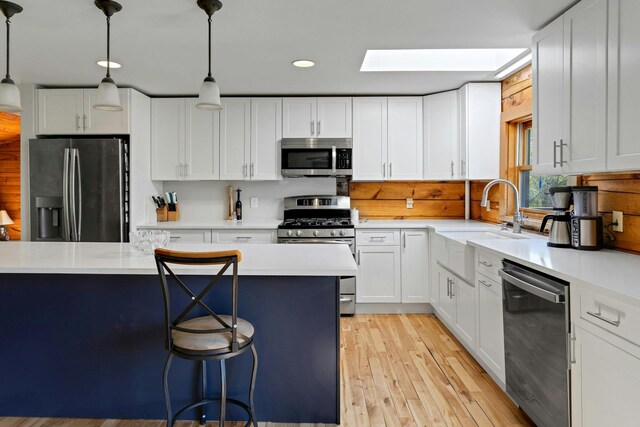 354 Sunset Hill Rd E, Fishkill, NY 12524 - kitchen with stainless steel appliances, light countertops, light wood-style flooring, white cabinets, and recessed lighting