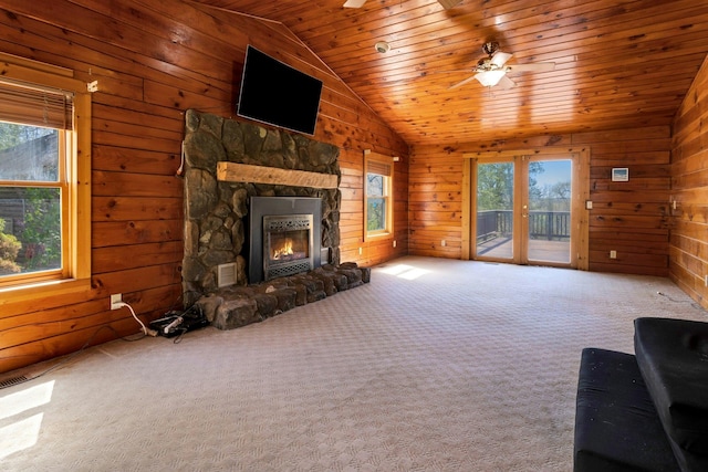 354 Sunset Hill Rd E, Fishkill, NY 12524 - unfurnished living room featuring wooden walls, lofted ceiling, wood ceiling, a stone fireplace, and carpet floors