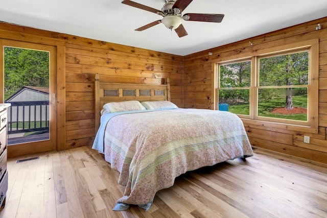 354 Sunset Hill Rd E, Fishkill, NY 12524 - bedroom with access to outside, light wood-type flooring, wooden walls, and ceiling fan
