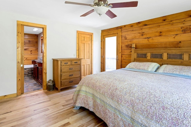 354 Sunset Hill Rd E, Fishkill, NY 12524 - bedroom featuring light wood-type flooring, wooden walls, ceiling fan, and connected bathroom
