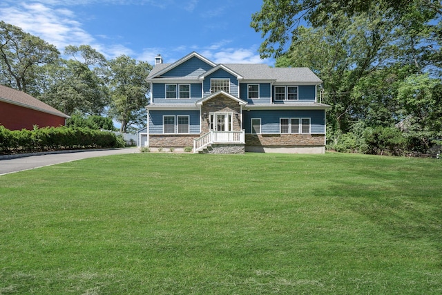 206 Brooksite Dr, Smithtown, NY 11787 - craftsman house featuring driveway, stone siding, a front lawn, and a chimney