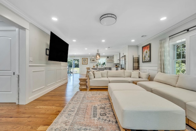206 Brooksite Dr, Smithtown, NY 11787 - living room with a decorative wall, crown molding, light wood-style flooring, and recessed lighting