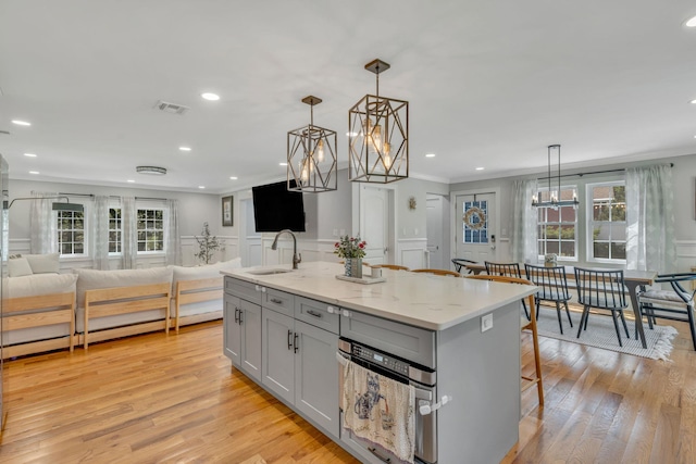 206 Brooksite Dr, Smithtown, NY 11787 - kitchen featuring open floor plan, a decorative wall, ornamental molding, plenty of natural light, and light wood-type flooring
