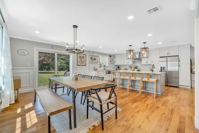 206 Brooksite Dr, Smithtown, NY 11787 - dining space featuring recessed lighting, light wood-style flooring, a decorative wall, a chandelier, and wainscoting