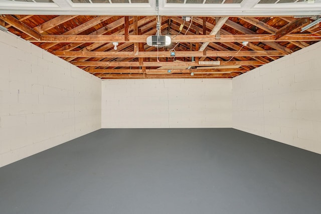 206 Brooksite Dr, Smithtown, NY 11787 - garage featuring concrete block wall and a garage door opener