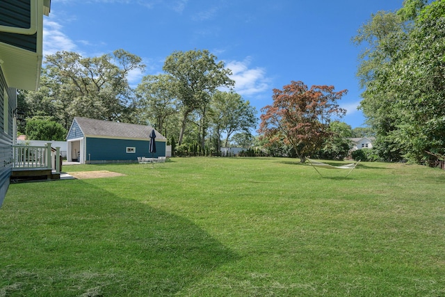 206 Brooksite Dr, Smithtown, NY 11787 - view of green lawn with an outdoor structure and a wooden deck