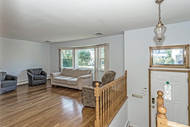 46 Pine St, Oceanside, NY 11572 - living room featuring a baseboard heating unit and wood finished floors