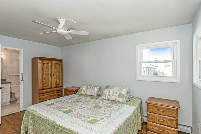 46 Pine St, Oceanside, NY 11572 - bedroom with a baseboard radiator, wood finished floors, ceiling fan, and connected bathroom