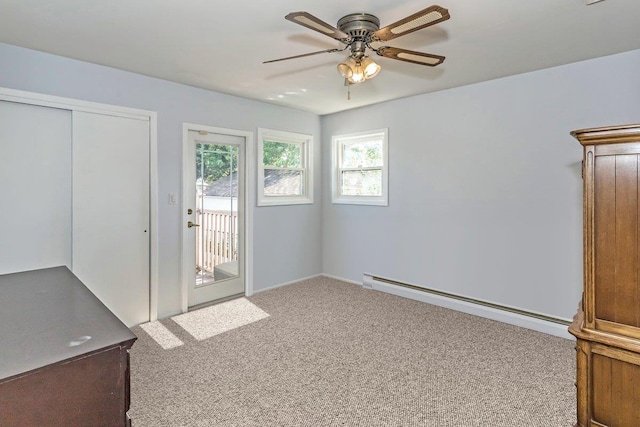 46 Pine St, Oceanside, NY 11572 - unfurnished bedroom featuring a baseboard radiator, access to outside, carpet floors, a closet, and a ceiling fan