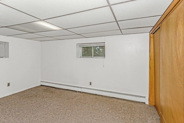46 Pine St, Oceanside, NY 11572 - basement featuring a baseboard radiator, a paneled ceiling, and carpet