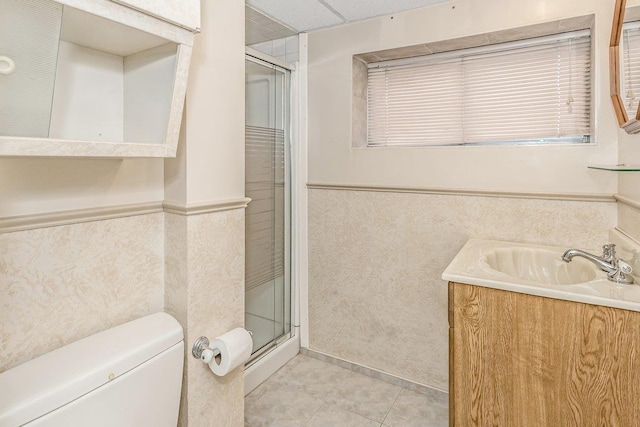 46 Pine St, Oceanside, NY 11572 - full bathroom with a wainscoted wall, vanity, a stall shower, and tile patterned floors