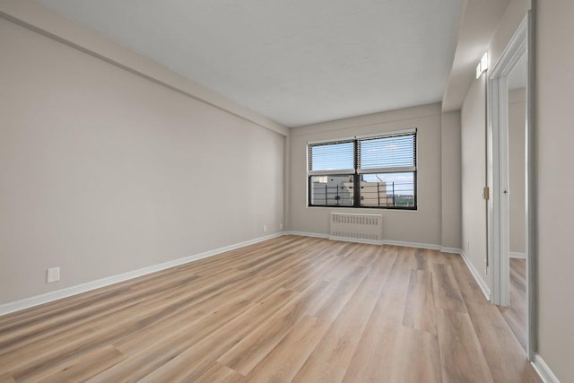 99-72 66th Rd Unit 9B, Rego Park, NY 11374 - spare room with radiator heating unit and light wood-style floors