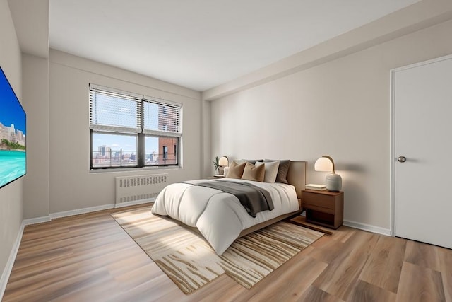 99-72 66th Rd Unit 9B, Rego Park, NY 11374 - bedroom with radiator heating unit and wood finished floors