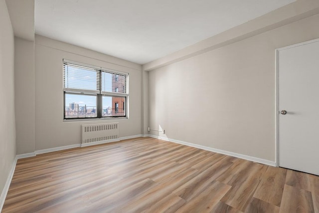 99-72 66th Rd Unit 9B, Rego Park, NY 11374 - spare room featuring radiator heating unit and light wood finished floors