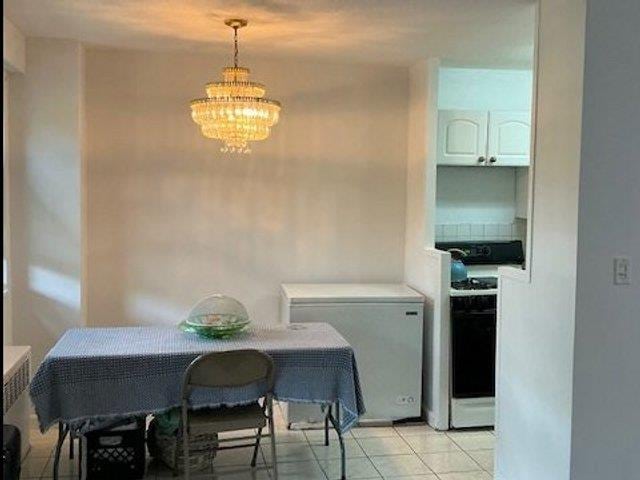 3410 De Reimer Ave Unit 2B, Bronx, NY 10475 - dining room featuring a chandelier and light tile patterned floors
