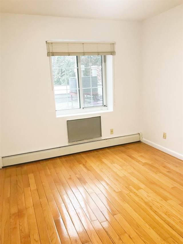 35-06LEAVITTST Leavitt St Unit 7F, Flushing, NY 11354 - empty room with a baseboard radiator and light wood-style flooring