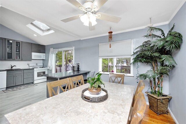 26 Shenandoah Blvd, Port Jefferson Station, NY 11776 - dining area featuring a skylight, light wood finished floors, healthy amount of natural light, a ceiling fan, and lofted ceiling