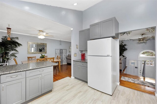 26 Shenandoah Blvd, Port Jefferson Station, NY 11776 - kitchen with freestanding refrigerator, ceiling fan, gray cabinets, and a towering ceiling