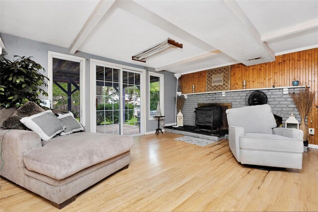 26 Shenandoah Blvd, Port Jefferson Station, NY 11776 - living area featuring beam ceiling, a wood stove, and light wood finished floors