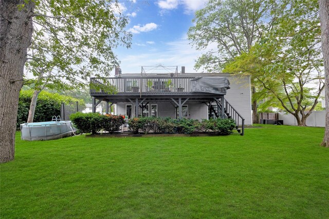 26 Shenandoah Blvd, Port Jefferson Station, NY 11776 - back of property featuring stairway, a wooden deck, and an outdoor pool