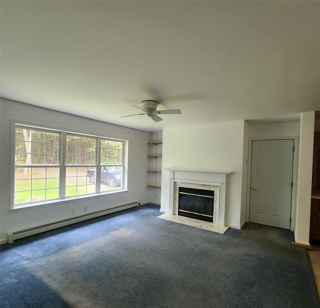 7219 State Rte 42, Grahamsville, NY 12740 - unfurnished living room featuring a baseboard heating unit, dark colored carpet, a ceiling fan, and plenty of natural light