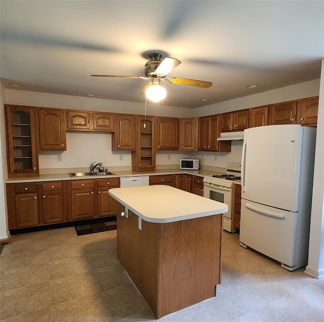 7219 State Rte 42, Grahamsville, NY 12740 - kitchen with white appliances, light countertops, a ceiling fan, under cabinet range hood, and brown cabinets