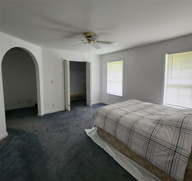 7219 State Rte 42, Grahamsville, NY 12740 - bedroom featuring arched walkways, dark carpet, a closet, and a ceiling fan