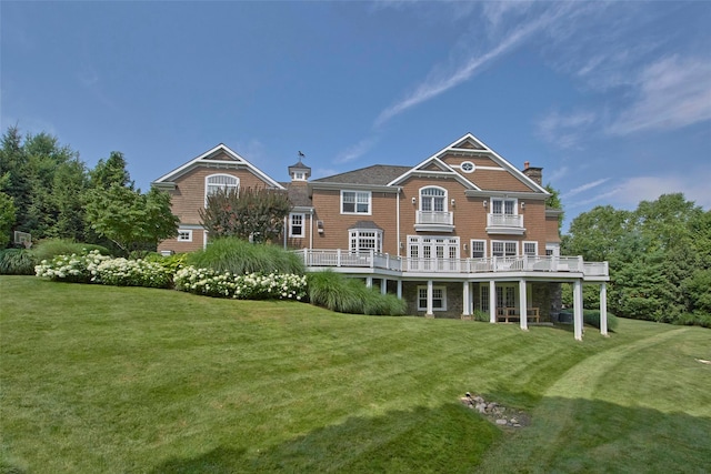 5 Sutton Farm Dr, Chappaqua, NY 10514 - back of property with a chimney, a yard, and a wooden deck