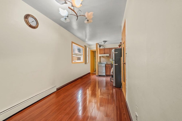 1314 College Point Blvd, College Point, NY 11356 - unfurnished living room featuring a baseboard radiator, a chandelier, and dark wood-style flooring