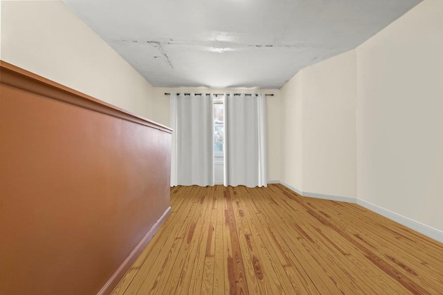 1314 College Point Blvd, College Point, NY 11356 - spare room with baseboards and light wood-type flooring