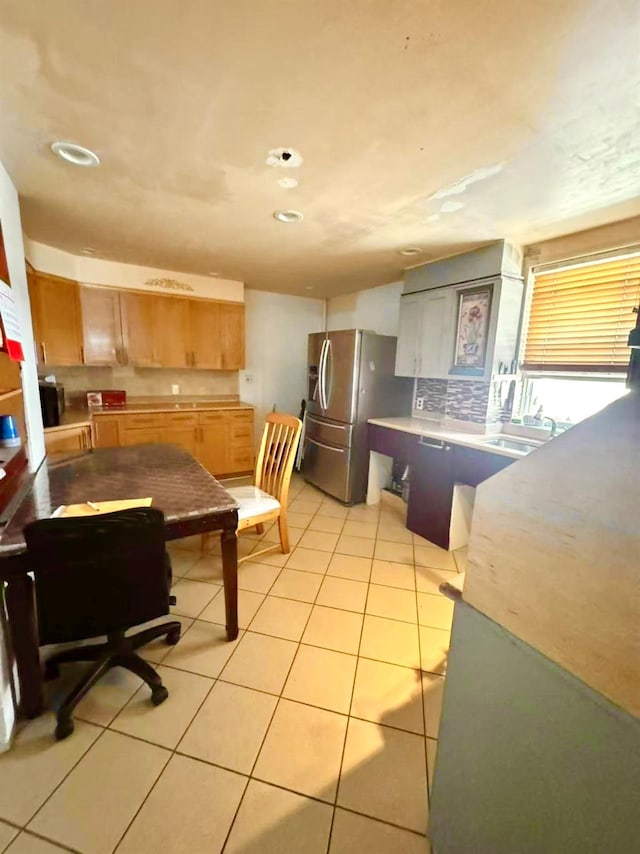1314 College Point Blvd, College Point, NY 11356 - kitchen featuring stainless steel fridge, light tile patterned flooring, light countertops, recessed lighting, and decorative backsplash