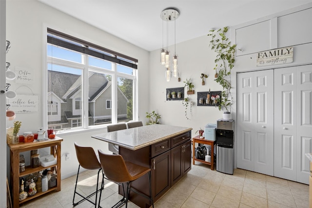 50 Corbin Hill Rd Unit 13, Fort Montgomery, NY 10922 - kitchen featuring light tile patterned flooring, dark brown cabinets, pendant lighting, and a center island