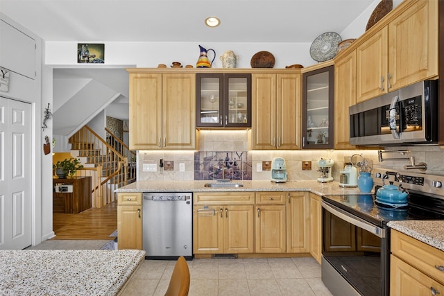 50 Corbin Hill Rd Unit 13, Fort Montgomery, NY 10922 - kitchen featuring stainless steel appliances, backsplash, light stone countertops, glass insert cabinets, and light brown cabinetry