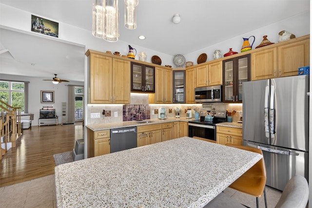 50 Corbin Hill Rd Unit 13, Fort Montgomery, NY 10922 - kitchen featuring appliances with stainless steel finishes, tasteful backsplash, decorative light fixtures, glass insert cabinets, and recessed lighting