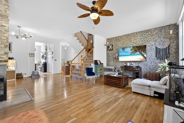 50 Corbin Hill Rd Unit 13, Fort Montgomery, NY 10922 - living room featuring stairway, light wood-type flooring, a ceiling fan, an accent wall, and wallpapered walls