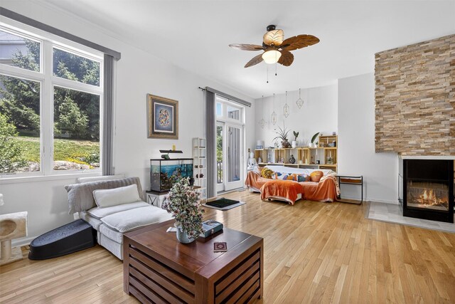 50 Corbin Hill Rd Unit 13, Fort Montgomery, NY 10922 - living area featuring a glass covered fireplace, light wood-type flooring, and healthy amount of natural light