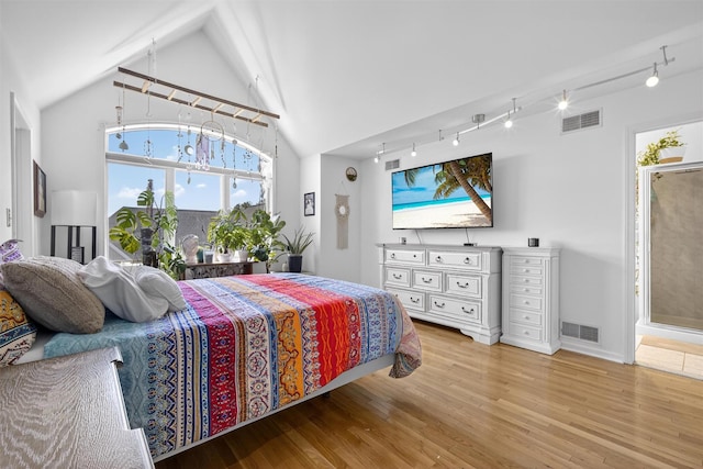 50 Corbin Hill Rd Unit 13, Fort Montgomery, NY 10922 - bedroom with track lighting, light wood-style floors, and vaulted ceiling