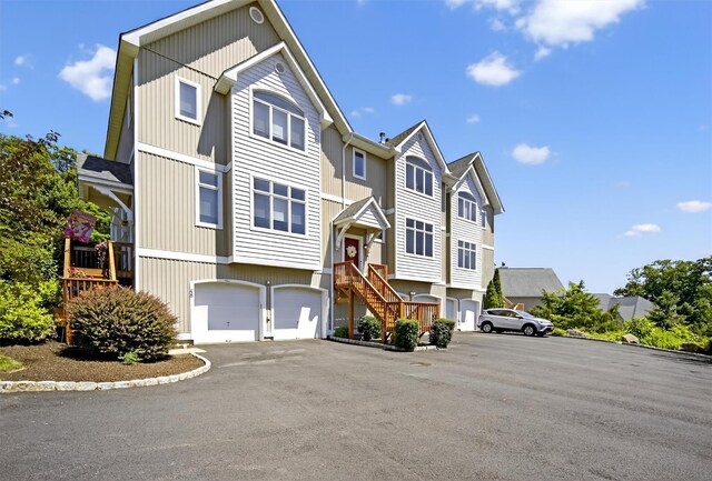 50 Corbin Hill Rd Unit 13, Fort Montgomery, NY 10922 - view of front of house with a residential view, a garage, and driveway