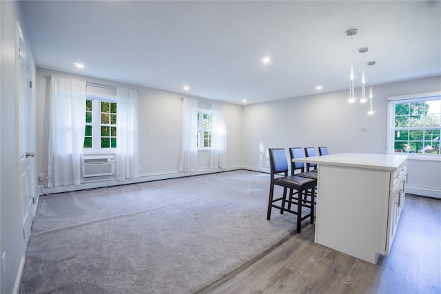 460 Old Town Rd Unit 4-O, Port Jefferson Station, NY 11776 - kitchen featuring recessed lighting, a center island, pendant lighting, white cabinets, and light countertops