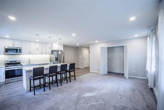 460 Old Town Rd Unit 4-O, Port Jefferson Station, NY 11776 - kitchen with stainless steel appliances, a center island, tasteful backsplash, recessed lighting, and light countertops