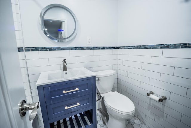 460 Old Town Rd Unit 4-O, Port Jefferson Station, NY 11776 - bathroom with tile walls, vanity, and a wainscoted wall