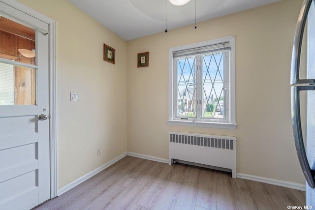 216 Raff Ave, Mineola, NY 11501 - unfurnished dining area with radiator heating unit, wood finished floors, and a ceiling fan