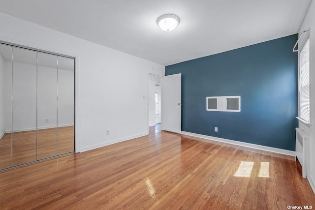 216 Raff Ave, Mineola, NY 11501 - unfurnished bedroom featuring light wood finished floors, a closet, and radiator heating unit