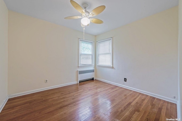 216 Raff Ave, Mineola, NY 11501 - empty room with radiator, wood finished floors, and a ceiling fan