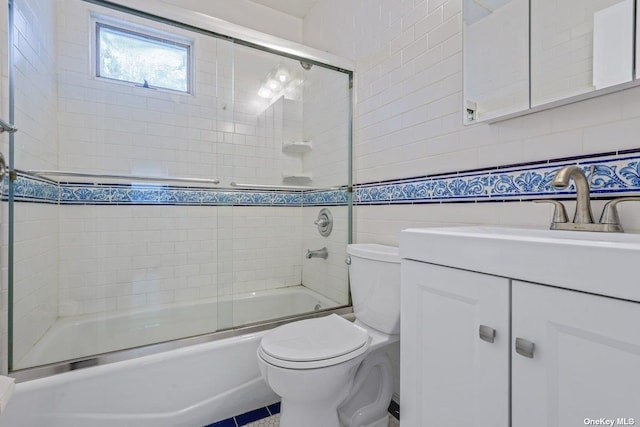 216 Raff Ave, Mineola, NY 11501 - bathroom with vanity, shower / bath combination with glass door, and tile walls