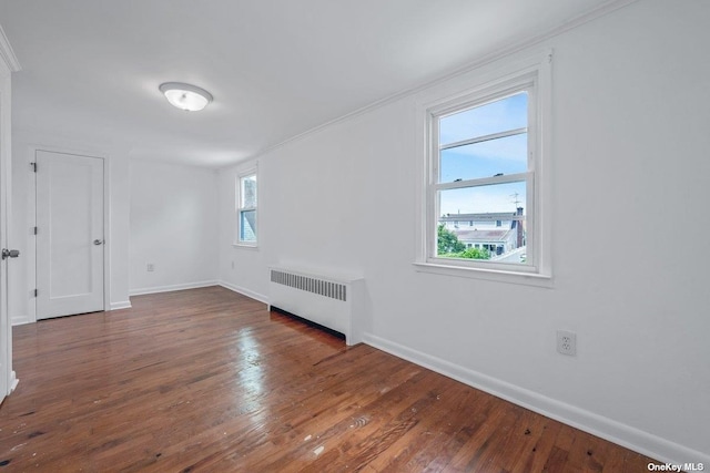 216 Raff Ave, Mineola, NY 11501 - spare room featuring radiator heating unit, plenty of natural light, wood-type flooring, and crown molding
