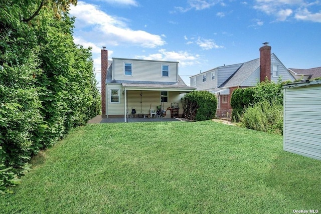 216 Raff Ave, Mineola, NY 11501 - back of house with a patio, a yard, and a chimney