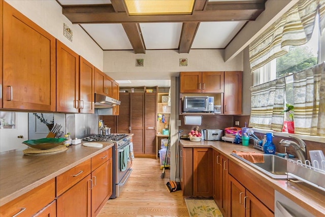 7 Wellesley Ave, Yonkers, NY 10705 - kitchen featuring gas stove, under cabinet range hood, light wood finished floors, beam ceiling, and brown cabinets