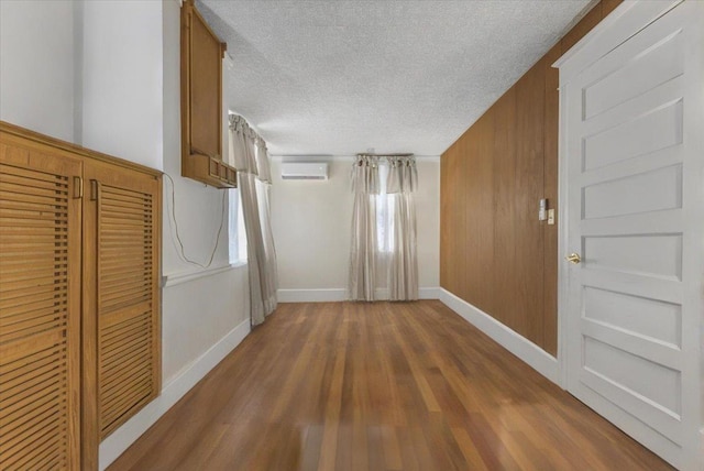 7 Wellesley Ave, Yonkers, NY 10705 - hallway with a textured ceiling, wood finished floors, and a wall mounted air conditioner